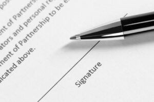 Merchant law firm pen and signature on contract image